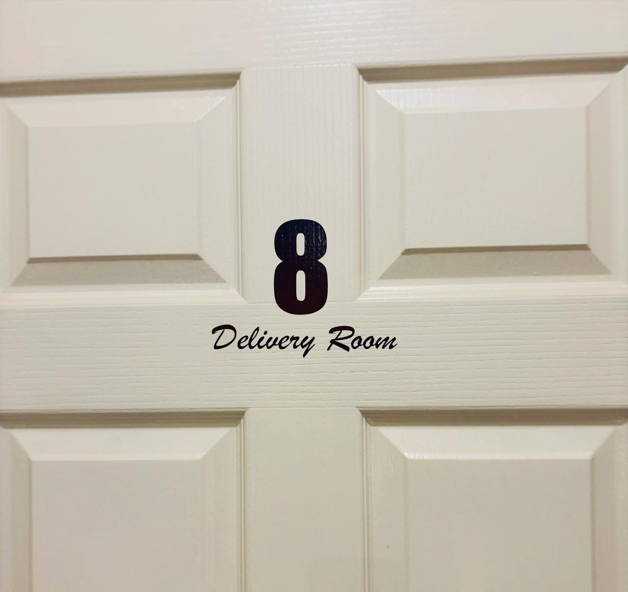 A white panelled door marked 8, Delivery Room